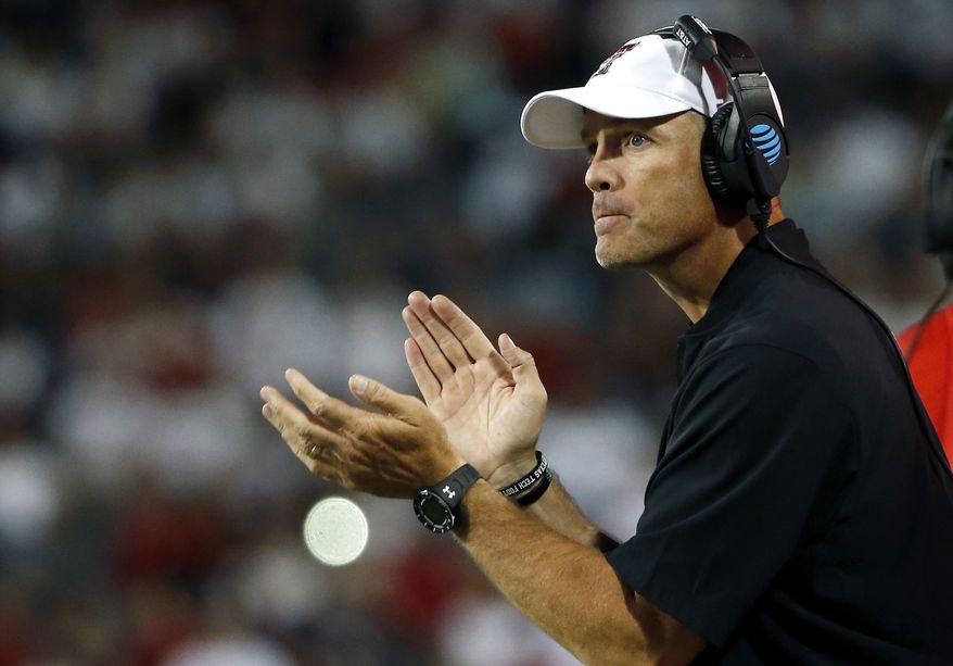 FILE - In this Sept. 14, 2019, file photo, Texas Tech coach Matt Wells applauds his team during the first half of an NCAA college football game against Arizona in Tucson, Ariz. Wells said at the start of this fall's camp that there was no question Alex Bowman was in line to take the first snap, and it was the sophomore quarterback's job “to solidify that role and extend his lead. It's up to him to play well.” (AP Photo/Ralph Freso, File)