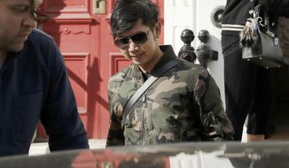 FILE - In this April 5, 2017, file photo, Vorayuth &amp;quot;Boss&amp;quot; Yoovidhya, whose grandfather co-founded energy drink company Red Bull, walks to get in a car as he leaves a house in London. A panel appointed by the Thai Prime Minister to look into the handling of the criminal case against an heir to the Red Bull energy drink fortune for a fatal hit-and-run incident has found there was a conspiracy to shield him from prosecution and recommended that those involved should face charges. (AP Photo/Matt Dunham, File)