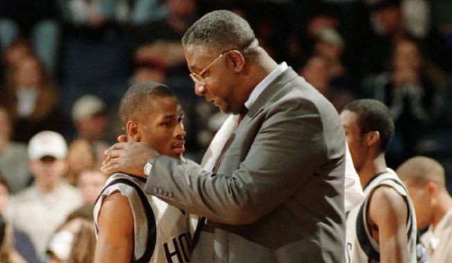 In this Jan. 24, 1996, file photo, Georgetown head coach John Thompson talks to Allen Iverson during an NCAA college basketball game against St. John&#x27;s, in Landover, Md. Thompson, the imposing Hall of Famer who turned Georgetown into a basketball powerhouse and became the first Black coach to lead a team to the NCAA men’s title, has died at age 78, his family announced through the university, Monday, Aug. 31, 2020. (Porter Binks/USA Today via AP, File)  **FILE**