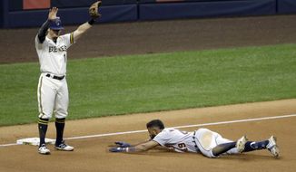 Detroit Tigers&#39; Willi Castro, right, slides in safely at third base past Milwaukee Brewers&#39; Eric Sogard after hitting an RBI-triple during the fourth inning of a baseball game Tuesday, Sept. 1, 2020, in Milwaukee. (AP Photo/Aaron Gash)