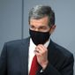 Gov. Roy Cooper adjust his mask as he listens to Dr. Mandy Cohen, secretary of the North Carolina Department of Health and Human Services, speak during a briefing at the Emergency Operations Center in Raleigh, N.C., Tuesday, Sept. 1, 2020. (Ethan Hyman/The News &amp;amp; Observer via AP)