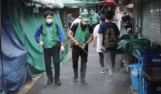 People disinfect as a precaution against the coronavirus at a local market in Seoul, South Korea, Wednesday, Sept. 2, 2020. (AP Photo/Lee Jin-man)