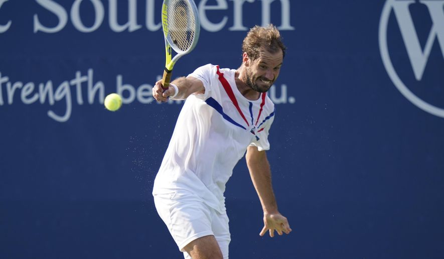 Richard Gasquet, of France, returns a shot against Roberto Bautista Agut, of Spain, during the second round at the Western & Southern Open tennis tournament Monday, Aug. 24, 2020, in New York. (AP Photo/Frank Franklin II)