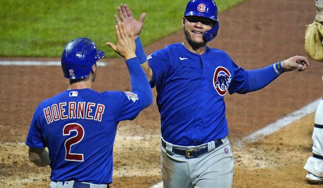 Chicago Cubs&#x27; Willson Contreras, right, and Nico Hoerner celebrate after both scored on a single by Anthony Rizzo off Pittsburgh Pirates relief pitcher Derek Holland during the seventh inning of a baseball game in Pittsburgh, Wednesday, Sept. 2, 2020. The Cubs won 8-2. (AP Photo/Gene J. Puskar)