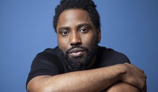 FILE - In this Nov. 14, 2018 photo, actor John David Washington poses for a portrait at the Four Seasons Hotel in Los Angeles. Washington stars in the Christopher Nolan film &amp;quot;Tenet.&amp;quot; (Photo by Rebecca Cabage/Invision/AP, File)
