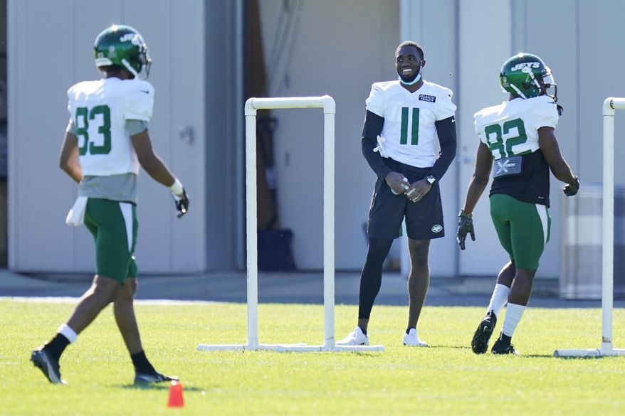 New York Jets' Denzel Mims (11) stand off to the side during a practice at the NFL football team's training camp in Florham Park, N.J., Thursday, Aug. 20, 2020. (AP Photo/Seth Wenig)