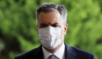 Lebanese Prime Minister-Designate Mustapha Adib wears a protective face mask as he arrives to attend a meeting with French President Emmanuel Macron at the presidential palace in Baabda, Lebanon, Tuesday, Sept. 1, 2020. rench President Emmanuel Macron returned to Lebanon on Monday, a country in the midst of an unprecedented crisis, for a two-day visit and a schedule packed with events and political talks aimed at charting a way out for the country. (Gonzalo Fuentes/Pool via AP)