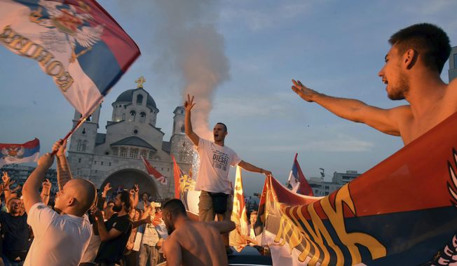 Opposition supporters celebrate after the parliamentary elections in front of the Serbian Orthodox Church of Christ&#x27;s Resurrection in Podgorica, Montenegro, Monday, Aug. 31, 2020.  A preliminary official tally on Monday of the country&#x27;s weekend parliamentary election indicates that the pro-Western party that has ruled the country for 30 years has won the most votes, but a coalition of three opposition groupings might still take power. (AP Photo/Risto Bozovic)
