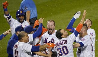 New York Mets&#39; Pete Alonso, center, and teammates celebrate after Alonso hit a two-run home run during the 10th inning of the team&#39;s baseball game against the New York Yankees, Thursday, Sept. 3, 2020, in New York. (AP Photo/Kathy Willens)