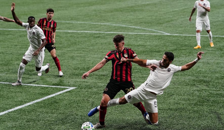 Atlanta United midfielder Emerson Hyndman, left, and Inter Miami defender Nicolas Figal, right, fight for the ball during the second half of an MLS soccer match on Wednesday, Sept. 2, 2020, in Atlanta. (AP Photo/Brynn Anderson)