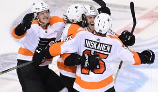 Philadelphia Flyers defenseman Ivan Provorov (9) celebrates his winning goal against the New York Islanders with teammates during the second overtime period of NHL Stanley Cup Eastern Conference playoff hockey game action in Toronto, Thursday, Sept. 3, 2020. (Frank Gunn/The Canadian Press via AP)