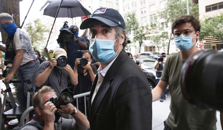 FILE - This July 24, 2020, file photo shows Michael Cohen, center, President Donald Trump&#39;s former personal attorney, returning to his apartment, in New York, after being released from prison. So-called Son of Sam laws won&#39;t keep Cohen from profiting from any part of his book, &amp;quot;Disloyal: The True Story of the Former Personal Attorney to President Donald J. Trump,&amp;quot; legal experts told The Associated Press, even if his memoir amounted to a how-to manual for tax evasion and campaign finance violations. (AP Photo/Mark Lennihan, File)