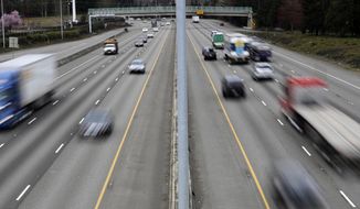 FILE - In this Monday, March 25, 2019, file photo, cars and trucks travel on Interstate 5 near Olympia, Wash. A new study says that safety features such as automatic emergency braking and forward collision warnings could prevent more than 40% of crashes in which semis rear-end other vehicles. (AP Photo/Ted S. Warren, File)