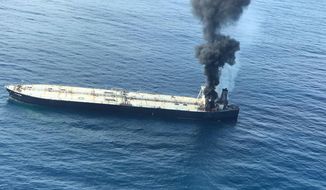 This photo released by Sri Lankan Air Force shows smoke rising after a fire broke out on a Panama-registered oil tanker about 38 nautical miles (70 kilometers) east of Sri Lanka, Thursday, Sept.3, 2020. (Sri Lankan Air Force via AP)