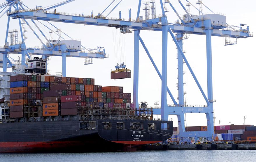 FILE - In this Nov. 4, 2019, file photo cargo cranes are used to take containers off of a Yang Ming Marine Transport Corporation boat at the Port of Tacoma in Tacoma, Wash. The U.S. trade deficit surged in July 2020 to $63.6 billion, the highest level in 12 years, as imports jumped by a record amount. The Commerce Department reported, Thursday, Sept. 3 2020, that the July deficit, the gap between what America buys and what it sells to foreigners, was 18.9% higher than the June deficit of $53.5 billion. (AP Photo/Ted S. Warren, File)