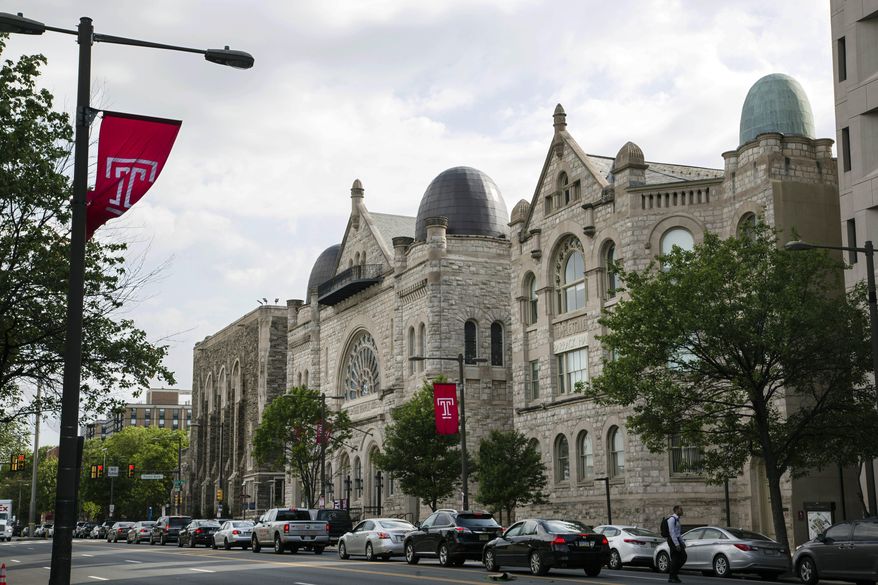 FILE — This May 23, 2019 file photo shows Temple University in Philadelphia. Amid rising numbers of positive coronavirus cases, Temple University announced Thursday, Sept. 3, 2020, that the majority of classes will shift to online through the end of the semester.(AP Photo/Matt Rourke, File)