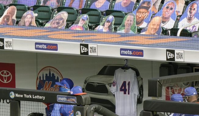 Tom Seaver&#x27;s No. 41 jersey hangs in the New York Mets dugout before the start of a baseball game against the New York Yankees at Citi Field, Thursday, Sept. 3, 2020, in New York. Seaver died on Aug. 31. (AP Photo/Kathy Willens)