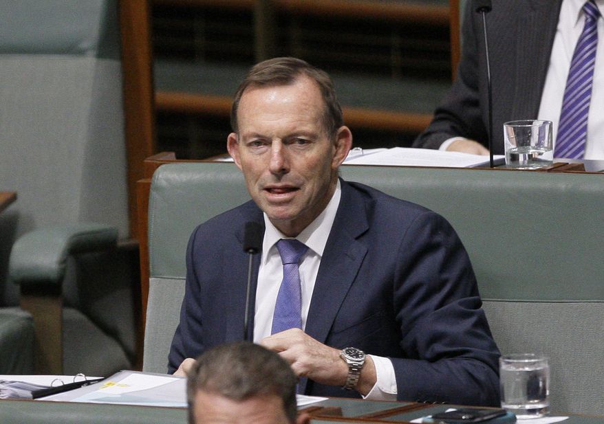 FILE - In this Monday, Aug. 20, 2018 file photo, former Australian Prime Minister Tony Abbott listens to lawmakers speak in Parliament in Canberra, Australia. Prominent equality and environmental activists, including “Lord of the Rings” star Ian McKellen have urged the British government to drop plans to make former Australian Prime Minister Tony Abbott a U.K. trade advisor. Prime Minister Boris Johnson’s government faced growing opposition Friday, Sept. 4, 2020 over reports it will appoint Abbott, who led a conservative Australian government between 2013 and 2015, to the U.K.’s Board of Trade. (AP Photo/Rod McGuirk, file)