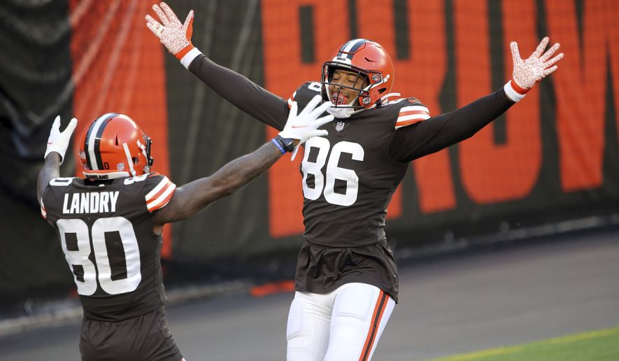 With no defense on the field for the drive, Cleveland Browns tight end Pharaoh Brown jokingly celebrates his touchdown catch with Jarvis Landry during the NFL football team's scrimmage Friday, Sept. 4, 2020, in Cleveland. (Joshua Gunter/Cleveland.com via AP)