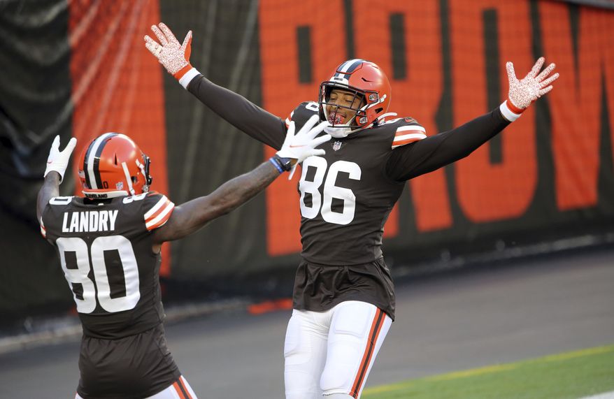 With no defense on the field for the drive, Cleveland Browns tight end Pharaoh Brown jokingly celebrates his touchdown catch with Jarvis Landry during the NFL football team's scrimmage Friday, Sept. 4, 2020, in Cleveland. (Joshua Gunter/Cleveland.com via AP)