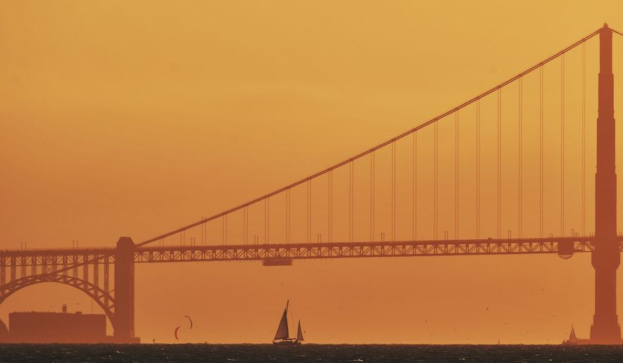 A sailboat sails past the Golden Gate Bridge as viewed from Treasure Island, Wednesday, Sept. 2, 2020, in San Francisco. Triple-digit temperatures are likely over a vast stretch of the state, and even coastal areas could see higher temperatures, forecasters said. (Jose Carlos Fajardo/Bay Area News Group via AP)