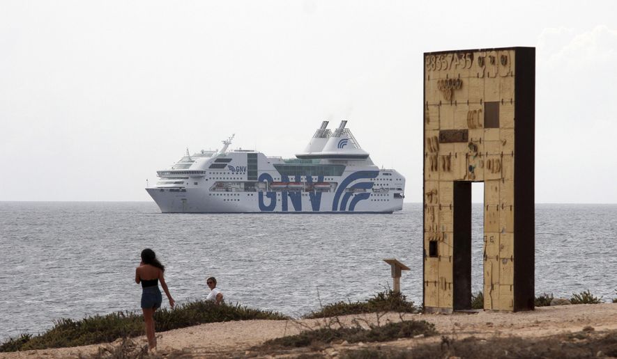 The GNV Rhapsody ferry is moored off the coast of Lampedusa island, Italy, Friday, Sept. 4 , 2020. Italian officials have been hastily chartered ferries and put other measures into place to fight severe overcrowding at migrant centers on the tiny island of Lampedusa. (AP Photo/Mauro Seminara)