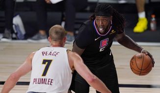 Los Angeles Clippers&#39; Montrezl Harrell (5) is defended by Denver Nuggets&#39; Mason Plumlee (7) in the second half of an NBA conference semifinal playoff basketball game Thursday, Sept 3, 2020, in Lake Buena Vista Fla. (AP Photo/Mark J. Terrill)
