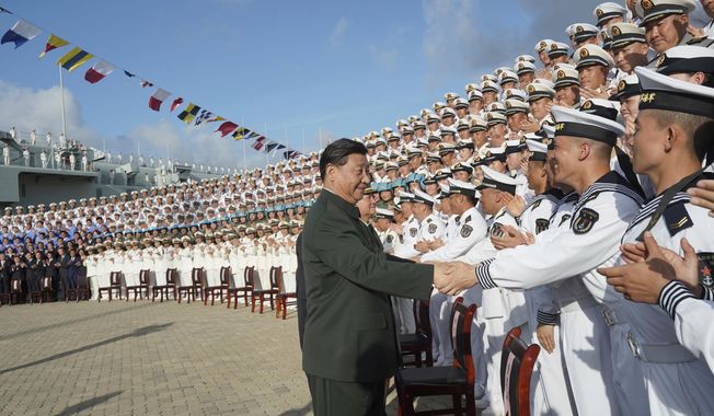 FILE - In this Dec. 17, 2019, file photo and provided by China&#x27;s Xinhua News Agency, Chinese President Xi Jinping, center, meets with representatives of the aircraft carrier unit and the manufacturer at a naval port in Sanya, southern China&#x27;s Hainan Province. Seventy-five years after Japan&#x27;s surrender in World War II, and 30 years after its economic bubble popped, the emergence of a 21st century Asian power is shaking up the status quo. As Japan did, China is butting heads with the established Western powers, which increasingly see its growing economic and military prowess as a threat. (Li Gang/Xinhua News Agency via AP, File)