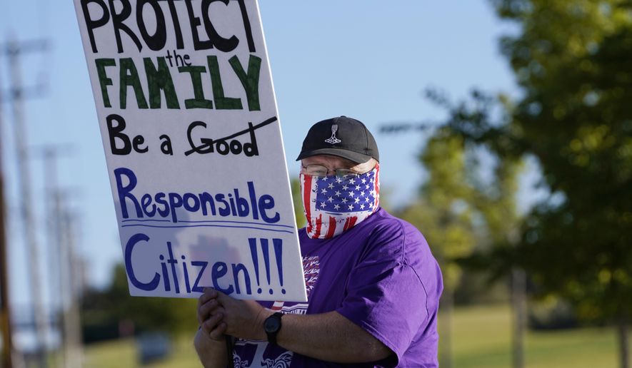 Law enforcement supporters protest during a Back the Blue rally Thursday, Sept. 3, 2020, in West Valley City, Utah. After months of protests around the nation over racial injustice in policing, police groups in Utah say they have grown frustrated with rhetoric they describe as unfair and called for The Salt Lake Tribune to apologize after it published an editorial cartoon linking the Ku Klux Klan with law enforcement. (AP Photo/Rick Bowmer)