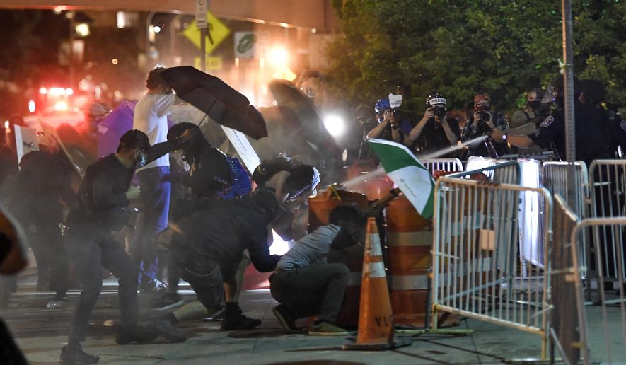Police spray an irritant at demonstrators outside the Public Safety Building in Rochester, N.Y., Thursday, Sept. 3, 2020. Seven police officers involved in the suffocation death of Daniel Prude in Rochester were suspended Thursday by the city&#39;s mayor, who said she was misled for months about the circumstances of the fatal encounter.(AP Photo/Adrian Kraus)
