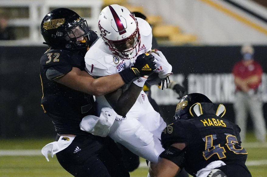 Southern Mississippi linebackers Hayes Maples (32) and Averie Habas (46) tackle South Alabama quarterback Desmond Trotter (1) after a short run during the first half of an NCAA college football game in Hattiesburg, Miss., Thursday, Sept. 3, 2020. (AP Photo/Rogelio V. Solis)