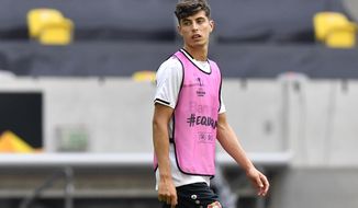 FILE - In this Sunday Aug. 9, 2020 file photo, Leverkusen&#39;s Kai Havertz looks around during a training session in Duesseldorf, Germany. Bayer Leverkusen forward Kai Havertz left the Germany national team training camp on Friday, Sept. 4 to try to complete his transfer to Chelsea. Leverkusen sports director Rudi Voeller said Havertz is traveling to London “so that Kai can now sort things out on the ground in London with our support.” (AP Photo/Martin Meissner, file)