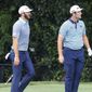 Dustin Johnson, left, and Jon Rahm watch Rahm&#x27;s tee shot to the par-3 second green during their first round of the Tour Championship golf tournament at East Lake Golf Club on Friday, Sept. 4, 2020, in Atlanta. (Curtis Compton/Atlanta Journal-Constitution via AP)