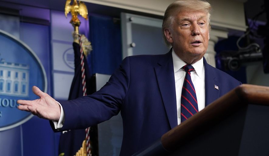 President Donald Trump gestures for Larry Kudlow, White House chief economic adviser, to speak during a news conference in the James Brady Press Briefing Room at the White House, Friday, Sept. 4, 2020, in Washington. (AP Photo/Evan Vucci)