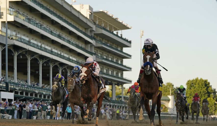 Jockey John Velazquez riding Authentic, right, crosses the finish line to win the 146th running of the Kentucky Derby at Churchill Downs, Saturday, Sept. 5, 2020, in Louisville, Ky. (AP Photo/Jeff Roberson)