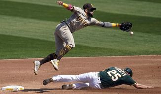 Oakland Athletics&#39; Stephen Piscotty, bottom, steals second base under San Diego Padres shortstop Fernando Tatis Jr. during the second inning of a baseball game in Oakland, Calif., Saturday, Sept. 5, 2020. (AP Photo/Jeff Chiu)