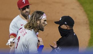 Philadelphia Phillies&#39; Bryce Harper, front left, argues with umpire Roberto Ortiz, right, after Ortiz ejected Harper during the fifth inning of the team&#39;s baseball game against the New York Mets, Saturday, Sept. 5, 2020, in New York. (AP Photo/John Minchillo)
