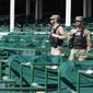 Military Police, working as security, stand in empty stands before the 146th running of the Kentucky Derby at Churchill Downs, Saturday, Sept. 5, 2020, in Louisville, Ky. (AP Photo/Mark Humphrey)