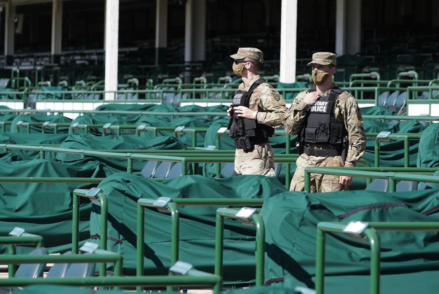 Military Police, working as security, stand in empty stands before the 146th running of the Kentucky Derby at Churchill Downs, Saturday, Sept. 5, 2020, in Louisville, Ky. (AP Photo/Mark Humphrey)
