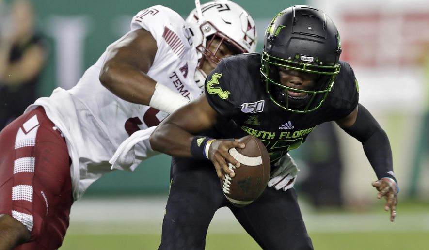 FILE - This Nov. 7, 2019, file photo shows Temple defensive end Quincy Roche trying to sack South Florida quarterback Jordan McCloud during the first half of an NCAA college football game in Tampa, Fla. While most of the offseason chatter surrounding college football transfers inevitably focuses on quarterbacks, plenty of notable players at other positions also switched teams and could make major impacts for their new schools this fall. Roche, the American Athletic Conference defensive player of the year last season, transferred to Miami. (AP Photo/Chris O'Meara, File)