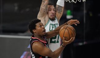 Toronto Raptors&#39; Kyle Lowry drives to the basket ahead of Boston Celtics&#39; Daniel Theis (27) during the first half of an NBA conference semifinal playoff basketball game Saturday, Sept. 5, 2020, in Lake Buena Vista, Fla. (AP Photo/Mark J. Terrill)