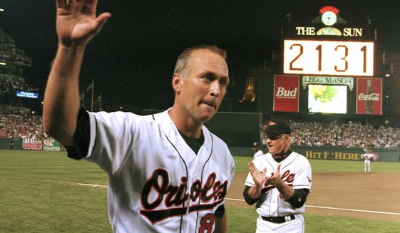 FILE - In this Sept. 6, 1995, file photo, Baltimore Orioles&#39; Cal Ripken Jr. waves to the crowd as the sign in centerfield reads 2,131, signifying Ripken had broken Lou Gehrig&#39;s record of playing in 2,130 consecutive games, at Camden Yards in Baltimore. It has been 25 years since Ripken broke Gehrig&#39;s major league record for consecutive games played, a feat the Orioles star punctuated with an unforgettable lap around Camden Yards in the middle of his 2,131st successive start. (AP Photo/Denis Paquin, File)