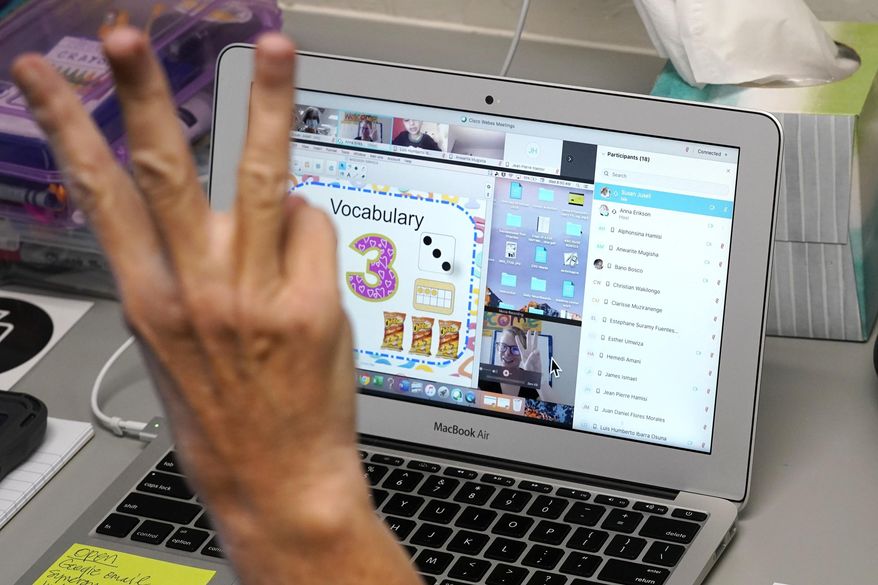 In this file photo from Sept. 2, 2020, a teaching assistant works in an empty classroom as she helps out with a remote learning class in Phoenix, Arizona. Public school students in Baltimore County, Md., have had their classes canceled for Nov. 30 and Dec. 1 following a ransomware attack on the county school system. (AP Photo/Ross D. Franklin) **FILE**
