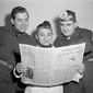 Former Olympic diver Sammy Lee, with co-workers at the hospital in Seoul, Korea, read the news of his award in the Stars and Stripes, Dec. 1953. From left: Cpl. Homer R. Banham of Paris, Mo.; Lee; and Capt. Jules A Howell of Winston-Salem, N.C. (AP Photo/George Sweers) ** FILE **