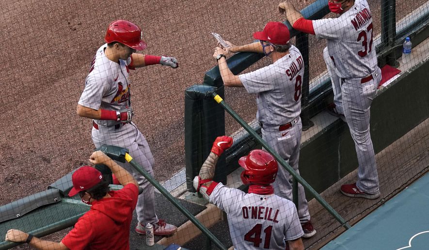 St. Louis Cardinals' Tommy Edman, left, celebrates with coaching staff members and a teammate after hitting a solo home run against the Chicago Cubs during the first inning of a baseball game in Chicago, Sunday, Sept. 6, 2020. (AP Photo/Nam Y. Huh)