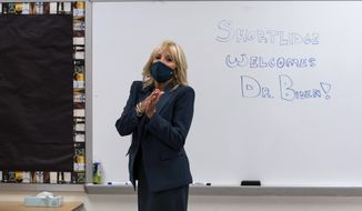 FILE - In this Sept. 1, 2020, file photo Jill Biden, wife of Democratic presidential candidate former Vice President Joe Biden, walks past a dry erase board in a classroom that reads &amp;quot;Shortlidge Welcomes Dr. Biden,&amp;quot; as she tours the Evan G. Shortlidge Academy in Wilmington, Del. In an election year where reopening schools shuttered by the coronavirus pandemic is emerging as a flashpoint, Jill Biden is increasingly drawing on her experience in the classroom to empathize with parents struggling to cope with the shift to virtual learning. (AP Photo/Carolyn Kaster, File)