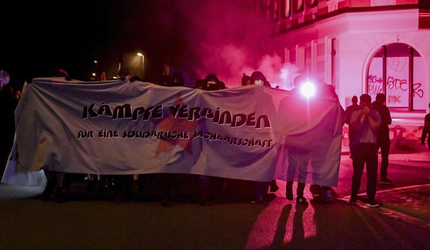 Participants of a demonstration march to support two squat dwellings through the Connewitz district of Leipzig, Germany, Saturday, Sept. 5, 2020. The demonstrators are marching under the motto &amp;quot;Connecting struggles - For solidarity neighbourhood,&amp;quot; after two squats in the city experienced violent riots. (Hendrik Schmidt/dpa via AP)