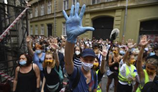 Students of the University of Theatre and Film Arts (SZFE) and their sympathizers form a human chain in protest against changes to the way the university is governed in Budapest, Hungary, Sunday, Sept. 6, 2020.  (Marton Monus/MTI via AP)