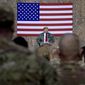 FILE - In this Dec. 26, 2018, file photo, President Donald Trump speaks to members of the military at a hangar rally at Al Asad Air Base, Iraq. Among veterans and military families across the United States, there are sharply mixed feelings about the new reports that Trump made multiple disparaging comments about the U.S. military. (AP Photo/Andrew Harnik, File)