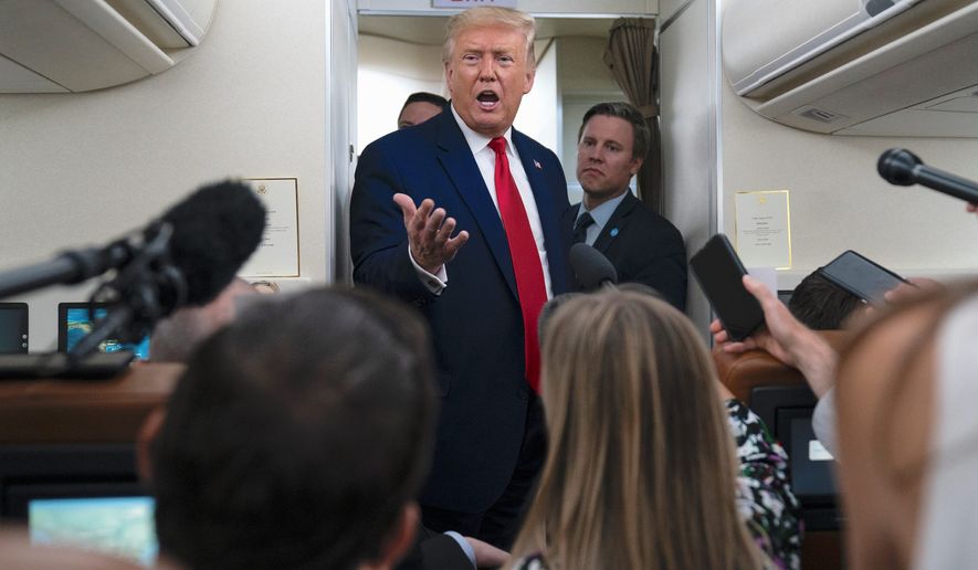 President Trump talks to reporters aboard Air Force One during a recent trip. An analysis finds that the media continues to help Joseph R. Biden by skipping evidence that Mr. Trump is &quot;on track&quot; to win the election. (Associated Press)